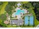 Aerial view of the community pool, clubhouse, tennis courts, and playground area at 19325 Hawk Valley Dr, Tampa, FL 33647
