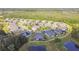Panoramic aerial view of a residential community featuring lush landscaping, ponds, and well-maintained homes at 19325 Hawk Valley Dr, Tampa, FL 33647