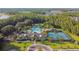 Aerial view of community pool, clubhouse, tennis courts, and lush landscaping at 19325 Hawk Valley Dr, Tampa, FL 33647