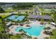 Aerial view showcasing the community pool, tennis courts, clubhouse, and scenic surroundings at 19325 Hawk Valley Dr, Tampa, FL 33647