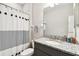 Bathroom features a granite countertop vanity and shower with stylish curtain at 19325 Hawk Valley Dr, Tampa, FL 33647