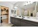 Bright bathroom with double vanity, marble countertop, and walk-in shower at 19325 Hawk Valley Dr, Tampa, FL 33647