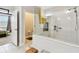 Bright bathroom featuring a glass-enclosed shower, tile floors, and an open doorway to the main bedroom at 19325 Hawk Valley Dr, Tampa, FL 33647