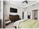 Bedroom features a comfortable bed, tray ceiling, and ample storage space at 19325 Hawk Valley Dr, Tampa, FL 33647