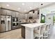 Modern kitchen featuring gray cabinets, stainless steel appliances, and a quartz countertop island at 19325 Hawk Valley Dr, Tampa, FL 33647