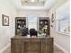 Bright home office features custom shelving, a large desk, and natural light at 19325 Hawk Valley Dr, Tampa, FL 33647
