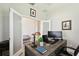 Well-lit home office with a large desk and adjacent seating area at 19325 Hawk Valley Dr, Tampa, FL 33647