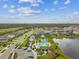 Aerial view of a beautiful community showcasing a lake, pool, and well-maintained homes at 19719 Cypress Bridge Dr, Odessa, FL 33556