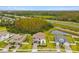 Aerial view of a home featuring lush landscaping, a large pond, and easy highway access at 19719 Cypress Bridge Dr, Odessa, FL 33556
