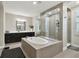 Elegant bathroom featuring a soaking tub, walk-in shower with glass, and modern fixtures for a luxurious feel at 19719 Cypress Bridge Dr, Odessa, FL 33556