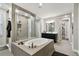 Bright bathroom features a soaking tub, walk-in shower, modern vanity and access to a large walk-in closet at 19719 Cypress Bridge Dr, Odessa, FL 33556