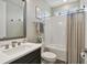 Bathroom with subway tile shower, dark vanity with white sink, and chrome fixtures at 19719 Cypress Bridge Dr, Odessa, FL 33556
