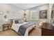 Cozy bedroom with lots of art, a padded headboard, and a window at 19719 Cypress Bridge Dr, Odessa, FL 33556