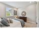Bedroom with padded headboard, soft lighting, neutral walls, a window and a wood dresser at 19719 Cypress Bridge Dr, Odessa, FL 33556