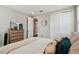 Relaxing bedroom featuring closet doors, dresser with decor, and neutral tones that create a cozy feel at 19719 Cypress Bridge Dr, Odessa, FL 33556