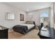 Cozy bedroom featuring a bed with patterned blanket, a desk, and neutral decor for a comfortable space at 19719 Cypress Bridge Dr, Odessa, FL 33556