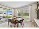 Bright dining area with contemporary table and chairs, plus backyard view through sliding glass doors at 19719 Cypress Bridge Dr, Odessa, FL 33556