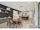 Spacious dining area adjacent to a modern kitchen, featuring a dark accent wall and stylish decor at 19719 Cypress Bridge Dr, Odessa, FL 33556