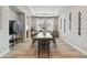 Dining room features a wooden table, modern black chairs, and tray ceiling at 19719 Cypress Bridge Dr, Odessa, FL 33556