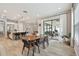 Open concept dining area with modern table, connected to the kitchen and outdoor patio for easy entertaining at 19719 Cypress Bridge Dr, Odessa, FL 33556