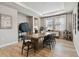 Dining room with a wooden table, modern chairs, and elegant lighting at 19719 Cypress Bridge Dr, Odessa, FL 33556