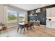 Stylish dining room with dark accent wall, modern furniture, and natural light from large windows at 19719 Cypress Bridge Dr, Odessa, FL 33556