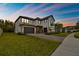 Beautiful two-story home featuring a three-car garage and a meticulously maintained lawn at 19719 Cypress Bridge Dr, Odessa, FL 33556