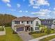 Beautiful two-story home featuring a paved driveway, a two car garage and manicured lawn at 19719 Cypress Bridge Dr, Odessa, FL 33556
