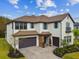 Two-story home boasts a tile roof, blue shutters, and a paved driveway leading to a three-car garage at 19719 Cypress Bridge Dr, Odessa, FL 33556