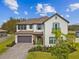 Stunning two-story home showcases manicured landscaping, a tile roof, and a three-car garage at 19719 Cypress Bridge Dr, Odessa, FL 33556
