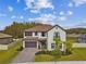 Stunning two-story home with a tile roof, well-manicured lawn, and inviting curb appeal at 19719 Cypress Bridge Dr, Odessa, FL 33556