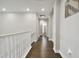 Well-lit hallway with hardwood flooring and decorative wall accents at 19719 Cypress Bridge Dr, Odessa, FL 33556