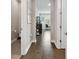 Inviting hallway showcasing wood floors leading to the rooms, complemented by soft neutral colors and natural light at 19719 Cypress Bridge Dr, Odessa, FL 33556