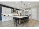 Beautiful kitchen with a large island, breakfast bar, white cabinets and stainless steel appliances for a modern look at 19719 Cypress Bridge Dr, Odessa, FL 33556