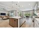 Bright, open kitchen with a large island, stainless steel appliances, and modern pendant lighting at 19719 Cypress Bridge Dr, Odessa, FL 33556
