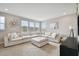 Bright living room featuring a large white sectional sofa, neutral walls, and natural light at 19719 Cypress Bridge Dr, Odessa, FL 33556
