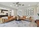 Bright living room boasts two leather sofas, a ceiling fan, and access to the kitchen at 19719 Cypress Bridge Dr, Odessa, FL 33556