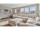 Bright living room showcasing a large white sectional sofa, neutral walls, and lots of windows at 19719 Cypress Bridge Dr, Odessa, FL 33556