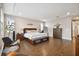 Spacious main bedroom with hardwood floors and tray ceilings offers a relaxing retreat at 19719 Cypress Bridge Dr, Odessa, FL 33556