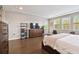 Airy main bedroom with large windows and wood floors offers a calming atmosphere at 19719 Cypress Bridge Dr, Odessa, FL 33556