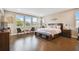 Bright main bedroom with hardwood floors, natural light and modern decor at 19719 Cypress Bridge Dr, Odessa, FL 33556