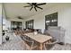 Covered patio area featuring a dining table, grill, and outdoor seating at 19719 Cypress Bridge Dr, Odessa, FL 33556