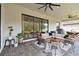 Comfortable covered patio with living and dining areas, ideal for outdoor entertaining at 19719 Cypress Bridge Dr, Odessa, FL 33556