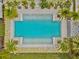 Aerial view of a community pool surrounded by palm trees and yellow lounge chairs at 19719 Cypress Bridge Dr, Odessa, FL 33556