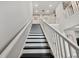 Elegant staircase with a white railing and dark wood steps leading upstairs at 19719 Cypress Bridge Dr, Odessa, FL 33556
