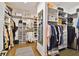 Spacious walk-in closet with custom shelving and racks for storage at 19719 Cypress Bridge Dr, Odessa, FL 33556