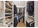 Walk-in closet features extensive shelving, hanging racks, and drawers for optimal organization at 19719 Cypress Bridge Dr, Odessa, FL 33556