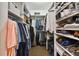 Large walk-in closet with ample hanging space and custom shoe storage at 19719 Cypress Bridge Dr, Odessa, FL 33556