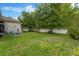View of the lush backyard featuring mature trees and a white picket fence at 20749 Auburn Leaf Trl, Land O Lakes, FL 34638