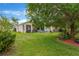 Wide view of the large yard showcasing lush grass and mature trees at 20749 Auburn Leaf Trl, Land O Lakes, FL 34638